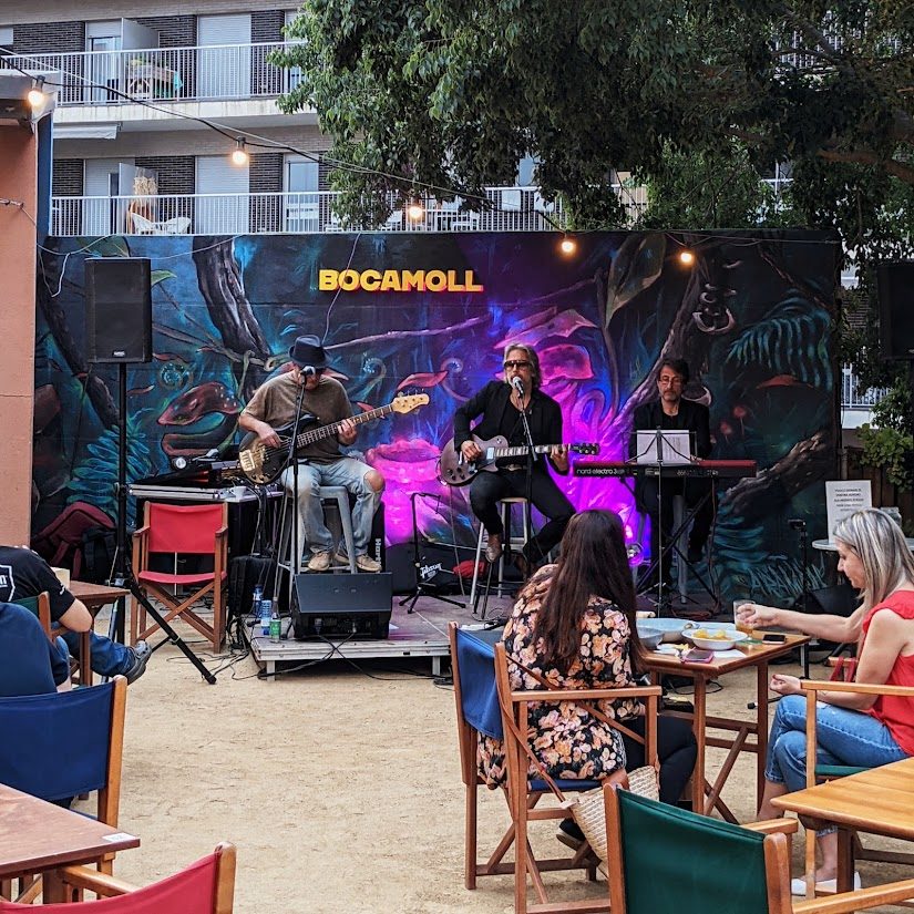Grupo tocando en vivo en la terraza del Bar Bocamoll con la gente cenando en las mesas
